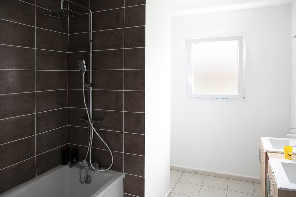 Salle de bain avec baignoire et meuble double vasque